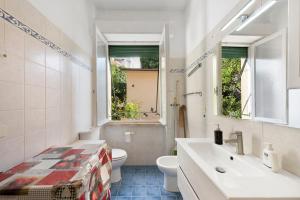 a bathroom with a sink and a toilet and a window at Apartment Beach next to 5 Terre in Bonassola +22 photos