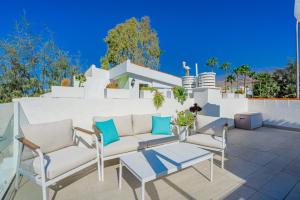 a patio with a couch and a table and chairs at La Perla in Callao Salvaje