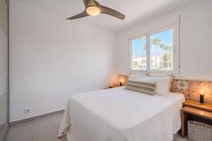 a white bedroom with a bed and a window at La Perla in Callao Salvaje +15 photos