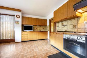 a large kitchen with wooden cabinets and a stove at Ferienwohnung Gatscherhof in Luson +12 photos