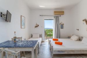 a room with two beds and a dining table at Perasma Studio 4 in Kipri