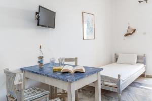 a room with a table with a bed and a book at Perasma Studio 4 in Kipri