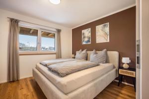 a bedroom with a large bed and a window at Ferienwohnung Alpenvorland in Seeg