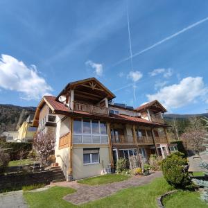 a large house with a gambrel roof at Haus Maria Bodensdorf in Tratten