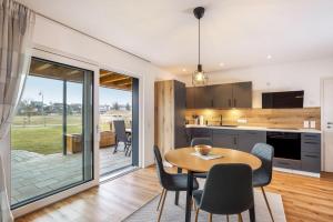 a kitchen and dining room with a table and chairs at Ferienwohnung Alpenvorland in Seeg