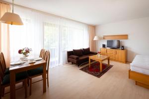 a living room with a couch and a table at Fewo Schneckenhalde App 12 in Bad Säckingen