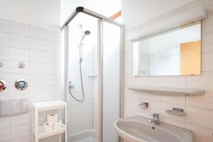 a white bathroom with a shower and a sink at Fewo Schneckenhalde App 12 in Bad Säckingen +15 photos