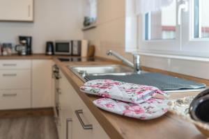 a kitchen counter with two plates and a sink at Mina in Krauchenwies