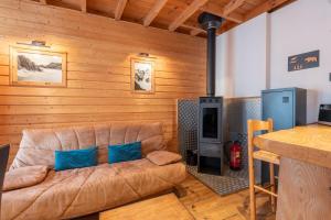 a living room with a brown couch and a table at Gîte Centre Luz-Saint-Sauveur in Luz-Saint-Sauveur