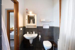 a bathroom with a sink and a toilet at Magic moment in Lake Como in Perledo