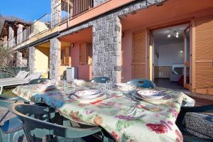 a table with glasses and plates on it on a patio at Magic moment in Lake Como in Perledo