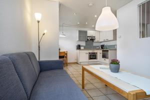 a living room with a couch and a table at Gästehaus Heinemann - Eg3 in Langenargen