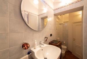 a bathroom with a sink and a mirror at Romantica Corte Degli Estensi in Ferrara +16 photos