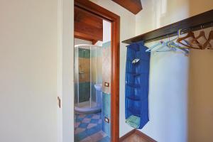 a bathroom with a shower with a blue shower curtain at Bed And Breakfast Sciarammola in Patti +51 photos