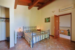 a bedroom with a bed and a door to a balcony at Bed And Breakfast Sciarammola in Patti