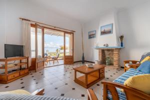 a living room with a tv and a fireplace at Cas Cover in Santa Margalida