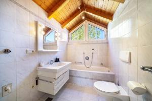 a bathroom with a sink and a toilet and a tub at Apartment Luisa in Silandro +14 photos