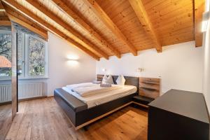 a bedroom with a bed in a room with wooden ceilings at Apartment Luisa in Silandro