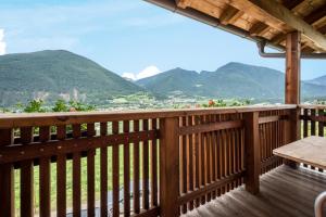 a wooden balcony with a view of mountains at Kreuzhof rechts in Novacella