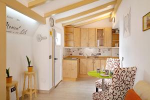 a kitchen with wooden cabinets and a green table at Isla Lobos in Playa Blanca
