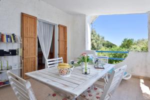 a dining room with a wooden table and chairs at Casa Vacanze Osala in Orosei