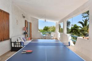 a living room with a blue ping pong table at Casa Vacanze Osala in Orosei +22 photos
