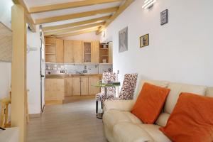 a living room with a couch and a kitchen at Isla Lobos in Playa Blanca +13 photos