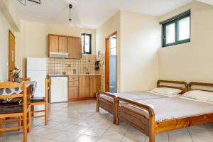 a bedroom with a bed and a kitchen at Daratos apartment 6 in Kefallonia