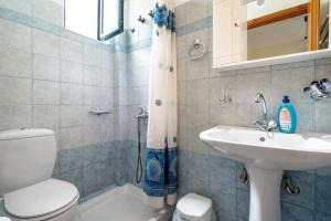 a bathroom with a toilet and a sink at Daratos apartment 6 in Kefallonia