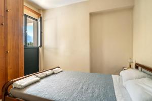 a bedroom with a bed and a window at Daratos apartment 6 in Kefallonia