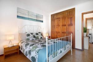 a bedroom with a bed and a wooden door at Isla and Ocean with pool and wifi in Costa Teguise +17 photos