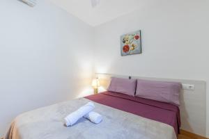 a bedroom with a bed with purple and white sheets at Tosca Mar 223 in Moraira +17 photos