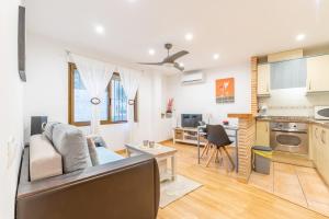 a living room and kitchen with a couch and a table at Tosca Mar 223 in Moraira