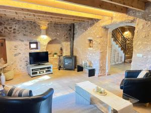 a living room with a tv and a fireplace at Casa Pina in Costitx