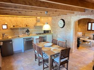 a kitchen and dining room with a table and chairs at Casa Pina in Costitx