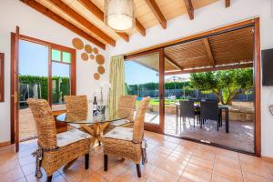 a dining room with a glass table and chairs at S'Hostalet in Islas Baleares