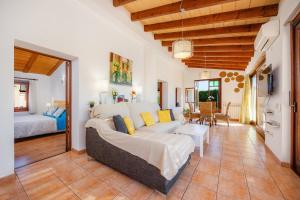 a living room with a couch and a bed at S'Hostalet in Islas Baleares