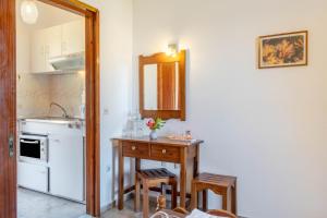 a kitchen with a table and a sink and a mirror at Mires House Side First Floor 10 in Agios Gordios