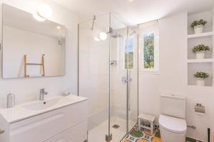 a bathroom with a shower and a toilet and a sink at Es Clos in El Port de la Selva +17 photos