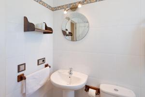 a white bathroom with a sink and a mirror at House Sun Beach 2 in Vejer de la Frontera +17 photos