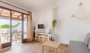 a living room with a couch and a table at Villa Estrellas 2 in Cala en Bosc