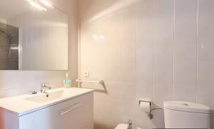 a bathroom with a sink and a toilet and a mirror at Villa Estrellas 2 in Cala en Bosc +12 photos