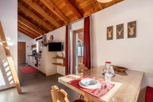a kitchen and dining room with a table and chairs at Ferienhaus Larch Soge Apt Karin in Racines