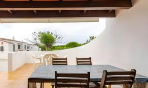 a dining room with a table and chairs at Villa Estrellas 2 in Cala en Bosc