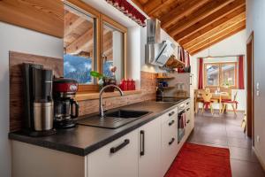 a kitchen with a sink and a counter top at Ferienhaus Larch Soge Apt Karin in Racines +10 photos