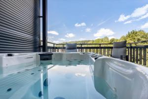 a hot tub on the deck of a house at Egge Resort 7b mit Whirpool u Sauna in Altenbeken
