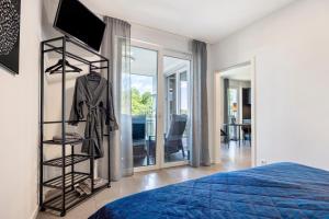 a bedroom with a bed and a room with a tv at Egge Resort 7b mit Whirpool u Sauna in Altenbeken +16 photos