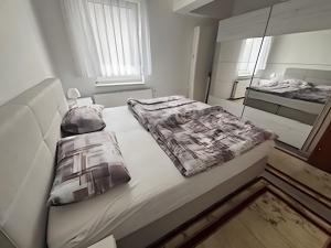 a large white bed with two pillows on it at Haci Babas Home in Bestwig