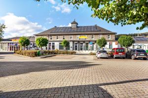 a large building with cars parked in a parking lot at Haci Babas Home in Bestwig