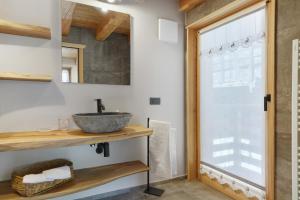 a bathroom with a sink and a mirror at Mas de la Tata in Rabbi +36 photos